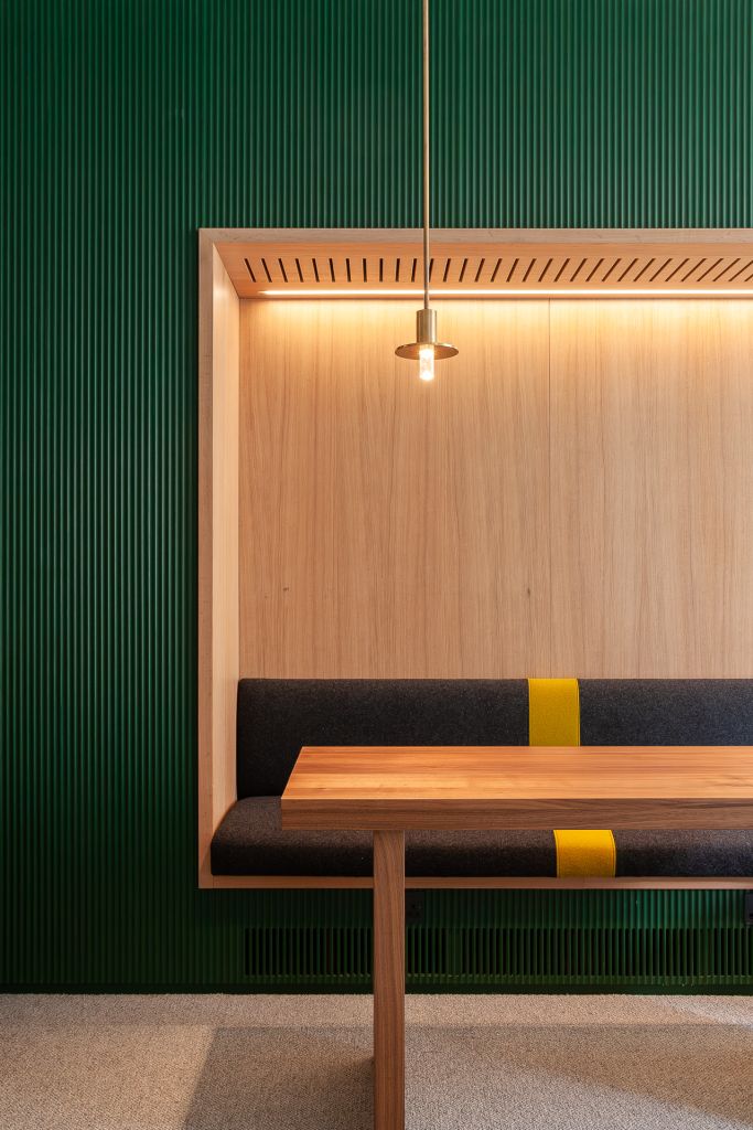 walnut table on front of recessed grey fabric seating