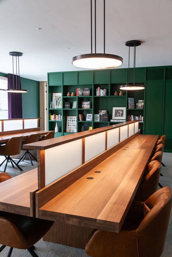 walnut study tables with frosted glass central divide and soft down lighting