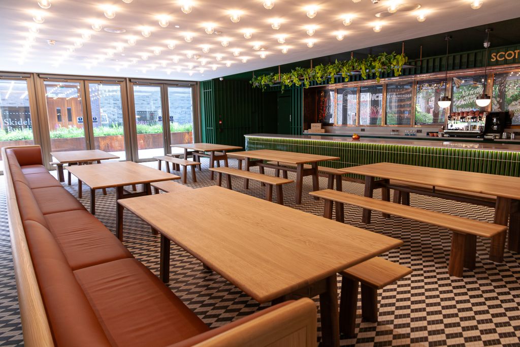 cafe area with long banquette seating plus tables and benches