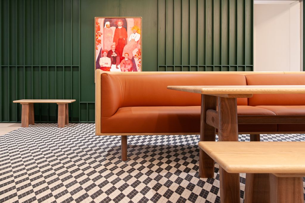 cafe banquette seating in oak and tan leather. oak table with walnut legs