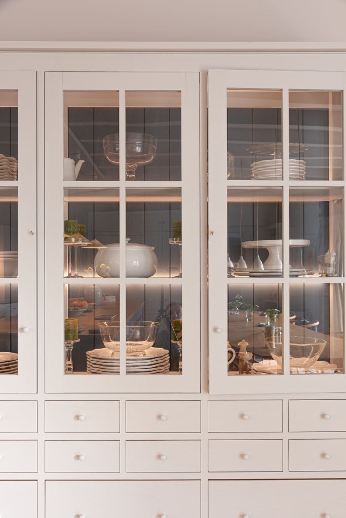 grey painted dresser with glass cabinet doors and led lighting