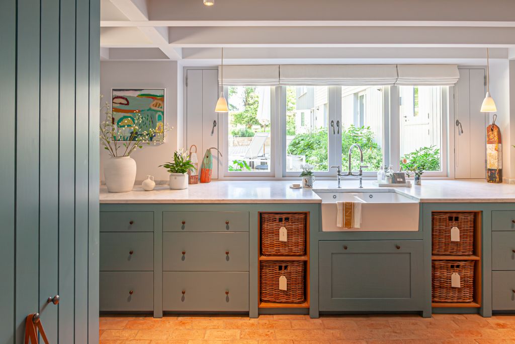 kitchen with belfast sink and wicker baskets